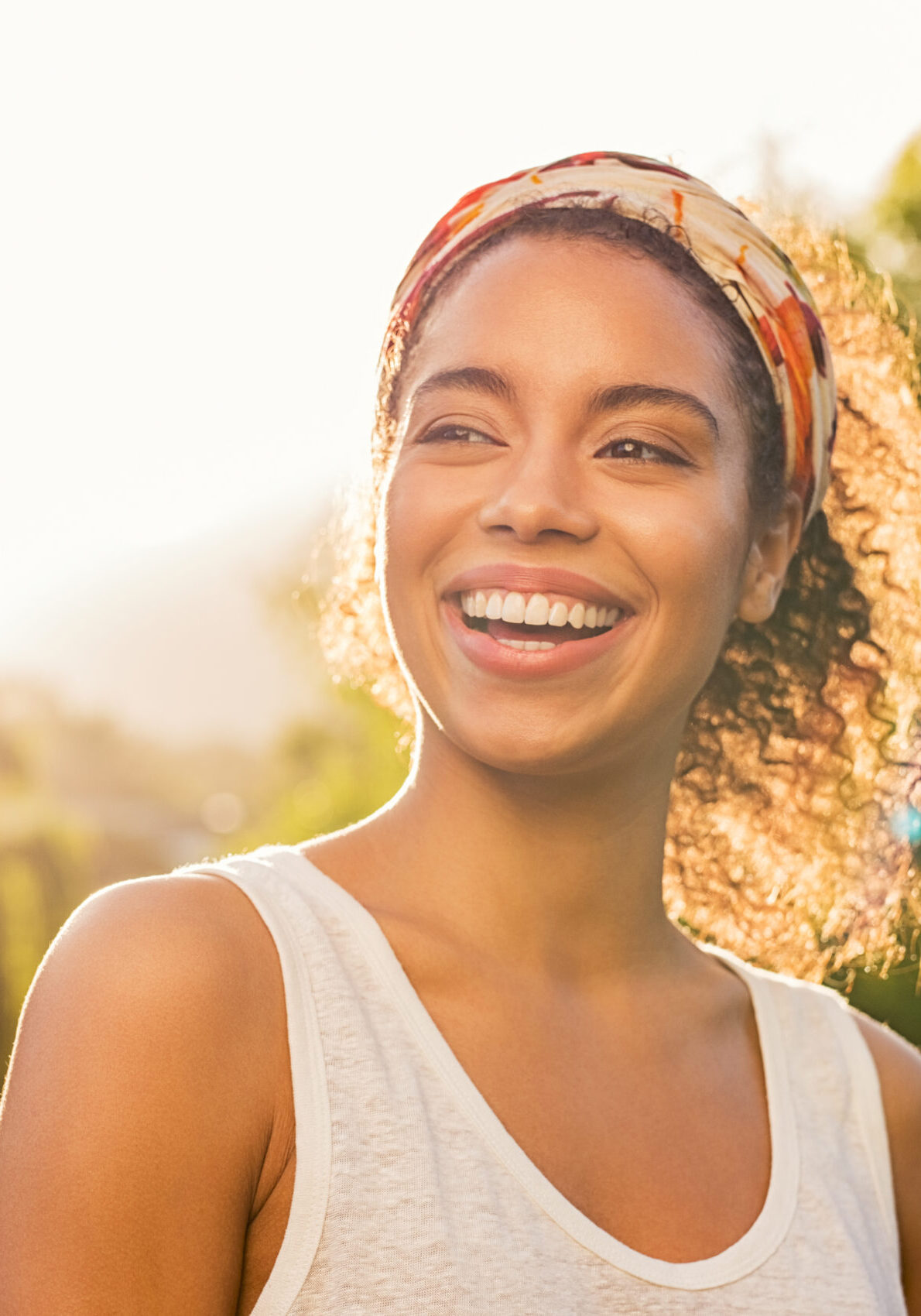 Young african woman smiling at sunset